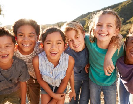 Portrait Of Multi-Cultural Children Hanging Out With Friends In The Countryside Together